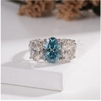 Three Stone Oval Ring with Blue Diamond and White Side Diamond