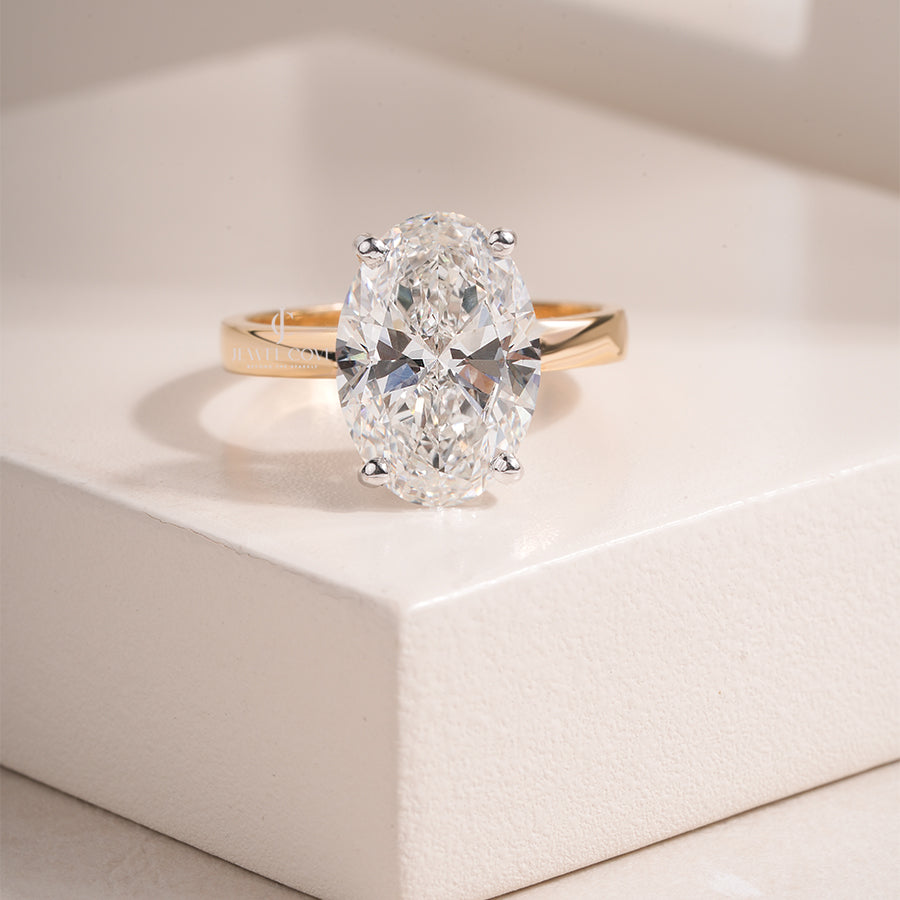 Oval Cut Moissanite Diamond Engagement Ring with Classic Four-Prong Setting and Gold Band