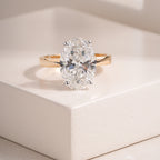 Oval Cut Moissanite Diamond Engagement Ring with Classic Four-Prong Setting and Gold Band