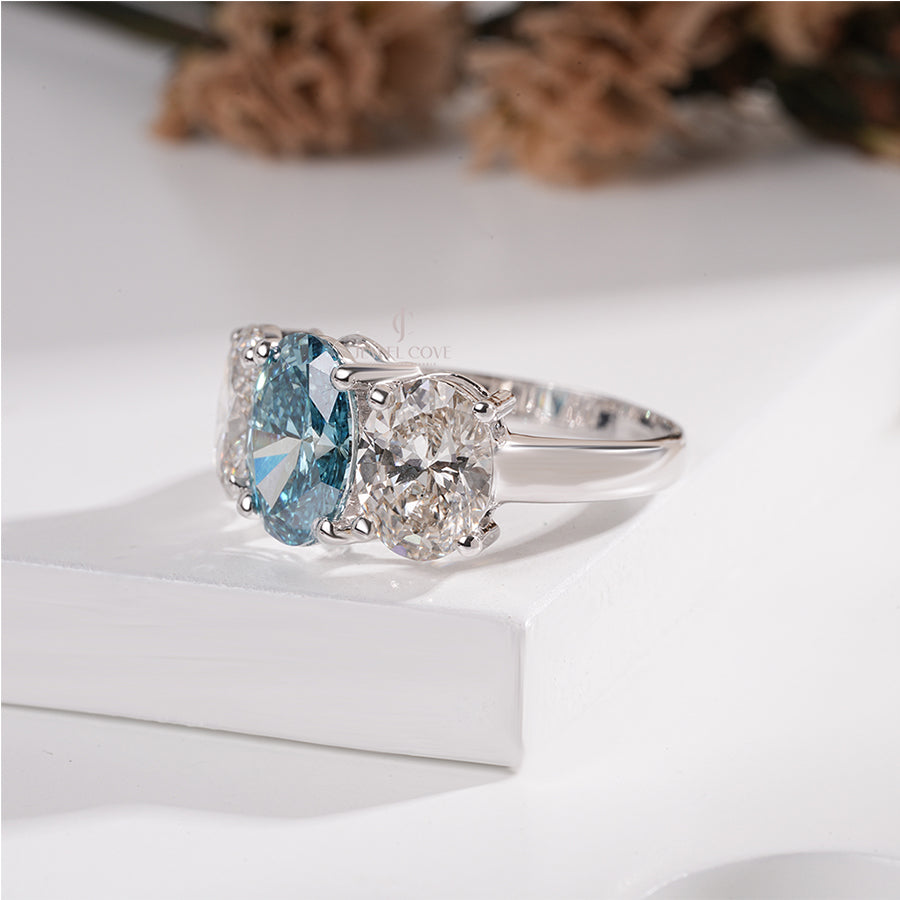 Three Stone Oval Ring with Blue Diamond and White Side Diamond